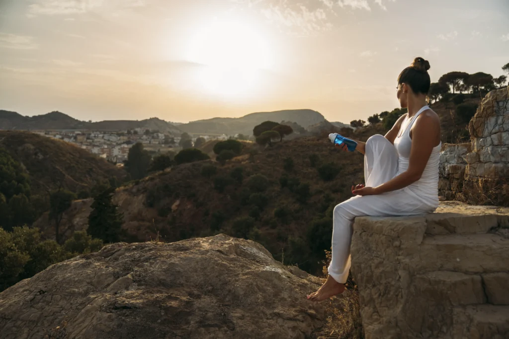 young-woman-posing-with-bottle-water-nature
